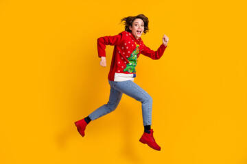 Fototapeta na wymiar Full length profile side photo of excited girl jump run hurry x-mas tradition discounts wear christmas tree sweater pullover denim jeans isolated bright shine color background