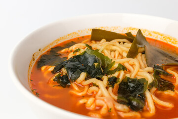 Spicy ramen on white background