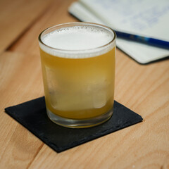 Tea Time Cocktail in thin rock glass on wood table