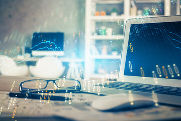 Financial chart drawing and table with computer on background. Double exposure. Concept of international markets.