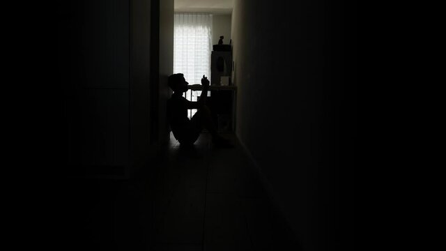 Desperate Man Alone in hallway checking his smartphone after girlfriend breaking up relationship.Static.