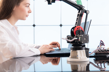 Woman student with robot model arm