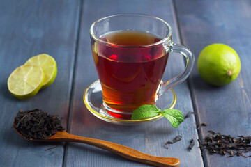 black tea in a transparent glass on the table