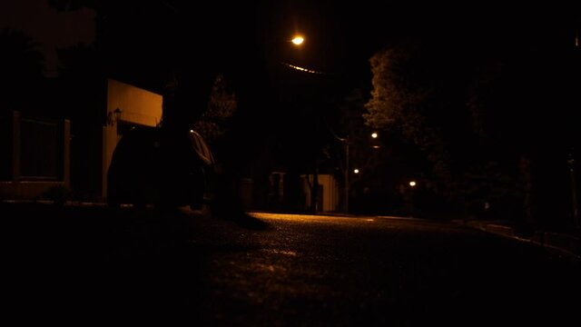 Healthy males shadow running down dark street at night exercise activity