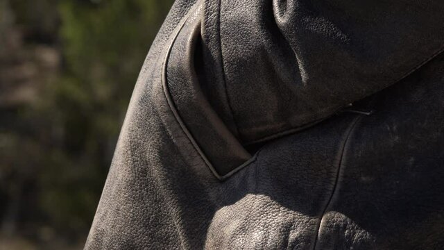 Man Pulls Unidentified Piece of Paper Out of Jacket Pocket, Close Up