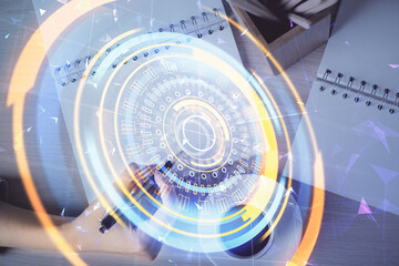 Obraz premium Technology theme hologram over woman's hands taking notes background. Concept of Tech. Double exposure