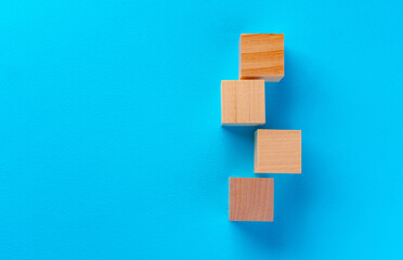 Top view of wooden toy blocks on blue