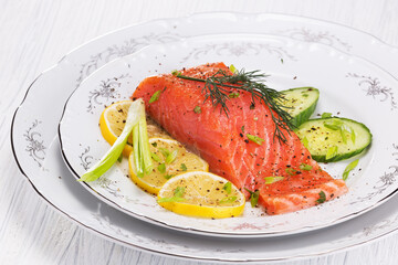 beautiful and delicious freshly salted red trout fish with lemon and herbs