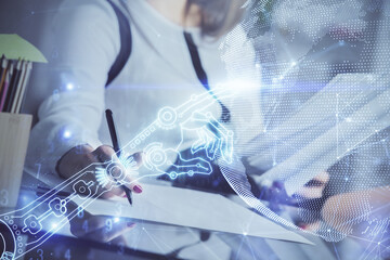 Technology theme hologram over woman's hands taking notes background. Concept of Tech. Double exposure