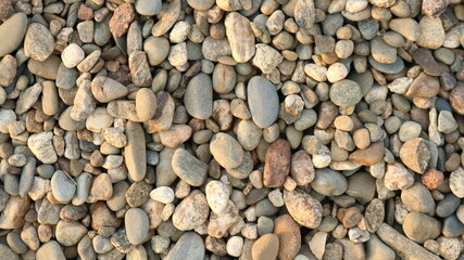 small stones of different colors and shapes in a natural land landscape