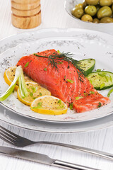 wonderful salted red trout fish with lemon, olives and herbs