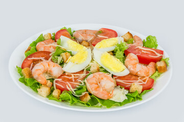 Caesar salad with fresh herbs in a white plate