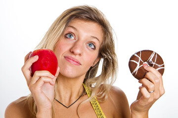 diet concept :woman in trouble between apple or donuts