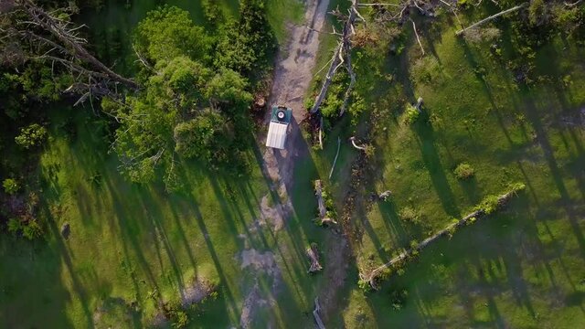 Aerial view above a off road truck driving on a forest dirt road, in rough terrain, at Cerro El Volcan, El Hatillo, Venezuela - overhead, drone shot
