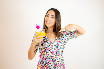 Woman showing a fruit juice in a glass