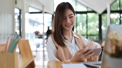 Female university student take a break with smartphone