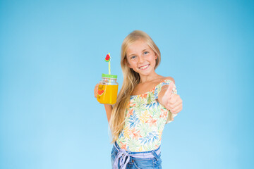 Girl with a fruit juice making a gesture of being well