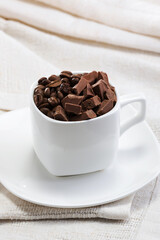 wonderful coffee beans with milk chocolate in a beautiful cup on the table
