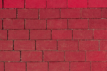 Top view on red paving stone road. Old pavement of granite texture. Abstract background for design.