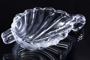 a small saucer of carved clear glass