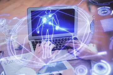 Science hologram with man working on computer on background. Concept of study. Double exposure.