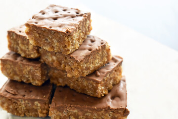 Chocolate rice crispy cake on white. Copy space is on the right side.