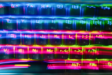 Rainbow stripes, RGB keyboard lubricated. Red, yellow, blue stripes. The effect of floating colored letters in bright colors.