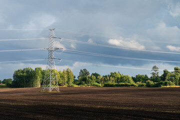 Electricity overhead line in a plowed field