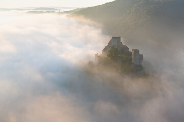 Hardegg medieval castle on a fortified hill upon Thaya river during summer or autumn time. Misty big ruins in the Thayatal Valley, National park, Lower Austria. The Smallest Austrian town.