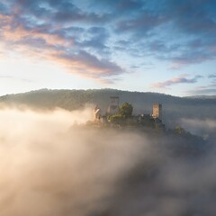 Hardegg medieval castle on a fortified hill upon Thaya river during summer or autumn time. Misty big ruins in the Thayatal Valley, National park, Lower Austria. The Smallest Austrian town.