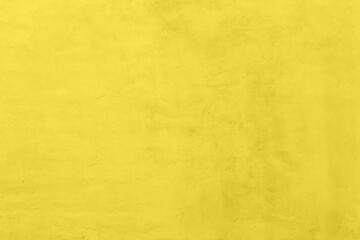 Saturated yellow colored low contrast Concrete textured background with roughness and irregularities. 2021 color trend.