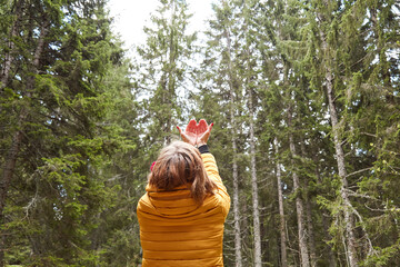 Woman with praying hands enjoying good vibes in the nature.