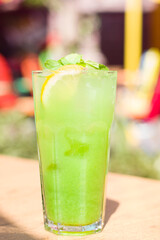 A glass of green citrus fruit cocktail