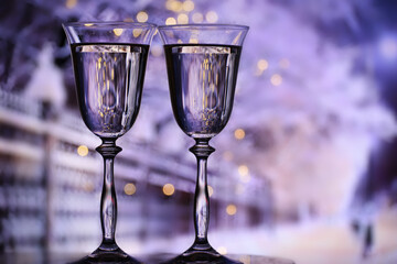 Two glasses of champagne against the backdrop of an evening winter look.
The atmosphere of a winter festive evening.