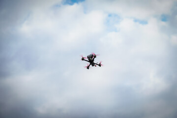 Naklejka na ściany i meble The flying racing drone is ready for the race.