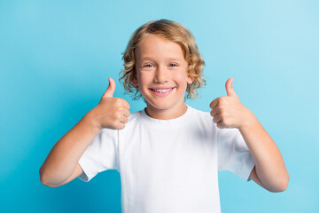 Photo of positive boy show thumb up sign wear casual style outfit isolated over blue color background