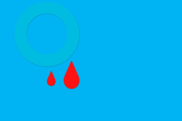 Blue circle isolated on blue background with some drops of blood as a symbol of diabetes. World diabetes day concept, 14 November.