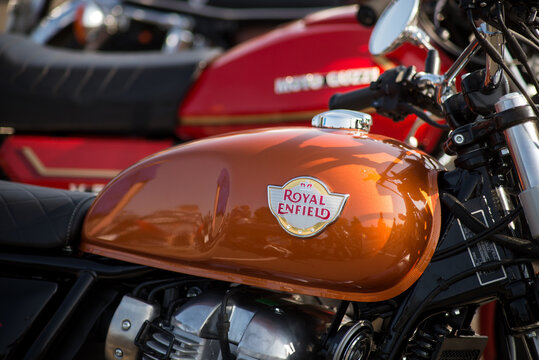 Mulhouse - France - 13 September 2020 - Closeup of royal enfield logo on orange tank of retro motorbike parked in the street