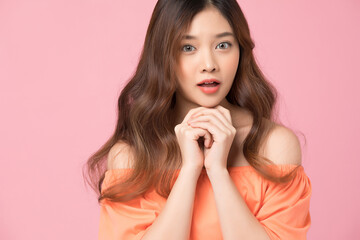 Fototapeta premium Portrait of beautiful woman posing gesture isolated on pink studio background