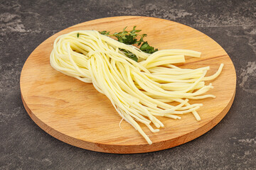 Chechil spaghetti cheese over board