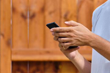 Person scrolls hand in smartphone on the street