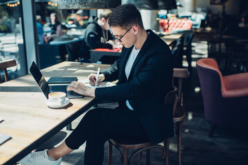 Focused businessman working while sitting in cafe
