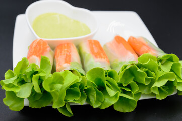 Crab stick salad rolls placed on a white plate