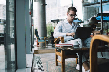 Thoughtful male entrepreneur working on laptop
