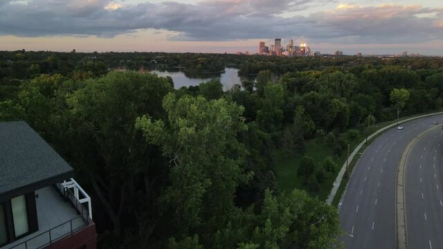 minneapolis during golden hour aerial view. downtown at the distance camera going on top of threes