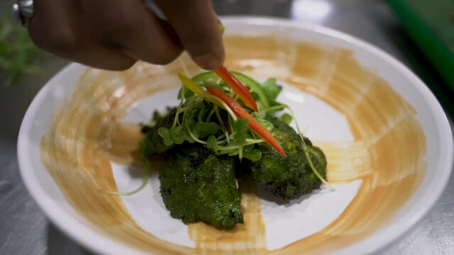 Chermoula Chicken Meal Garnish With Fresh Watercress Green Vegetables And Sliced Bell Pepper. - Close Up Shot