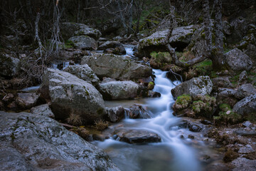 River water flows among the rocks and forms small waterfalls, Rascafría, Madrid, Spain