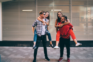 Caucasian male and female best friends enjoying weekend meeting for piggyback battle gaming at...