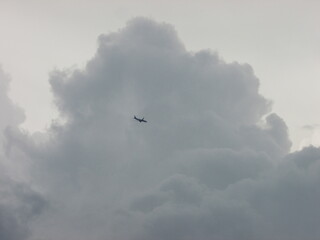 airplane flying in the sky, travel, wander lust, dramatic clouds. Journey concept.
