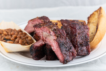 BBQ meal of half slab of ribs, baked beans, and butter toasted bread will taste as delicious as it...